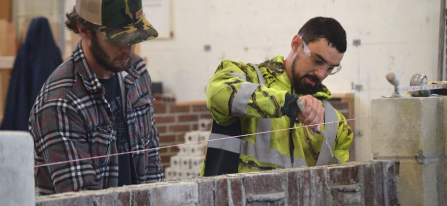 students practicing masonry work